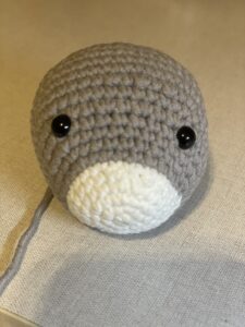 a knitted grey and white animal head