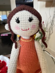 a knitted doll with braids