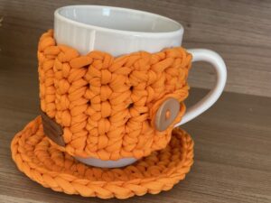 a mug with a knitted cover